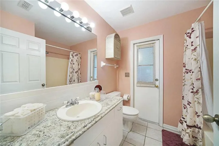 The guest bathroom doubles as the pool bath & has a shower/tub combo