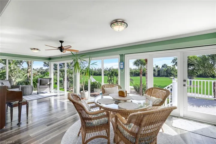 Sunroom / solarium featuring wood finished floors