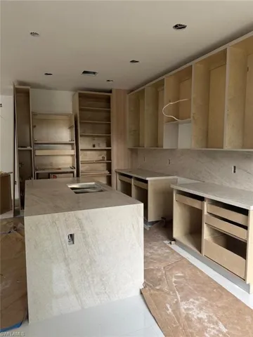 Kitchen featuring an island with sink