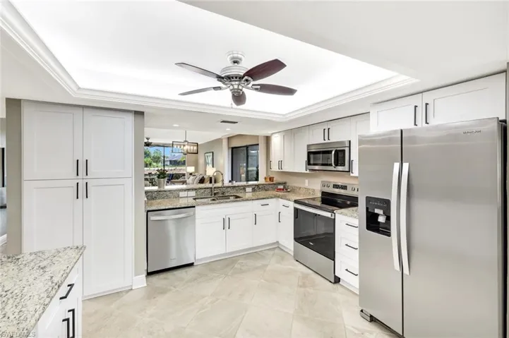 White, Soft Close Cabinetry, Tray Ceiling, Recessed Lighting, Tile Flooring