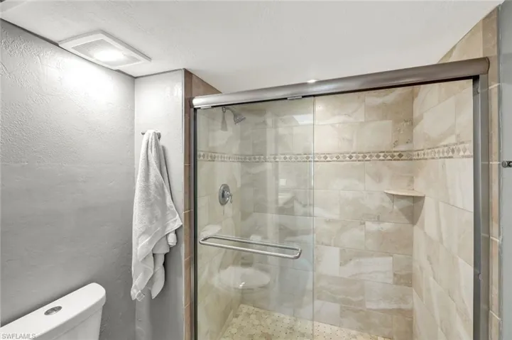 Large Step In Tiled Shower, Glass Doors