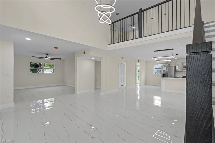 Living room featuring a high ceiling and chandelier