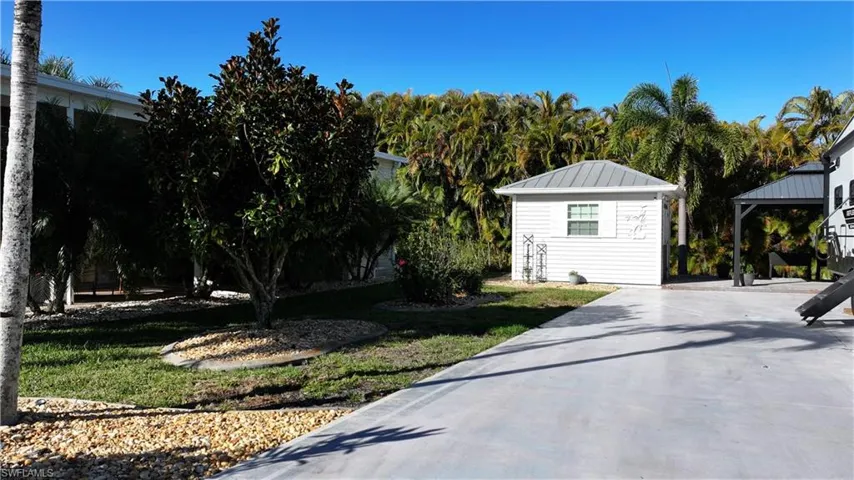 View of grassy yard with a gazebo and an outbuilding