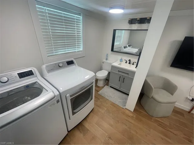 Laundry area featuring light wood-style floors and independent washer and dryer