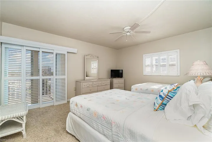 Bedroom featuring carpet flooring, ceiling fan, and access to exterior