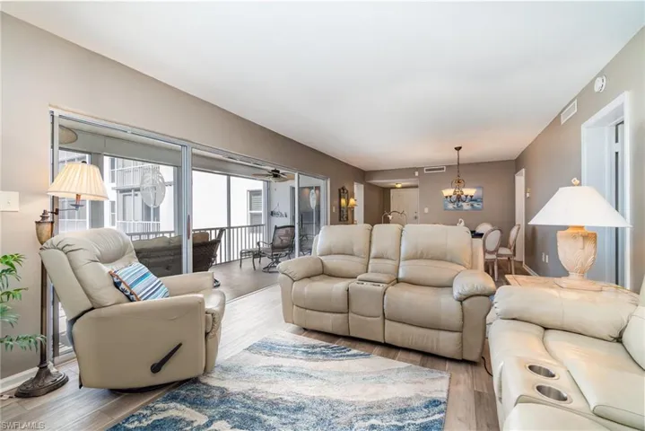 Living area with wood finished floors and a chandelier