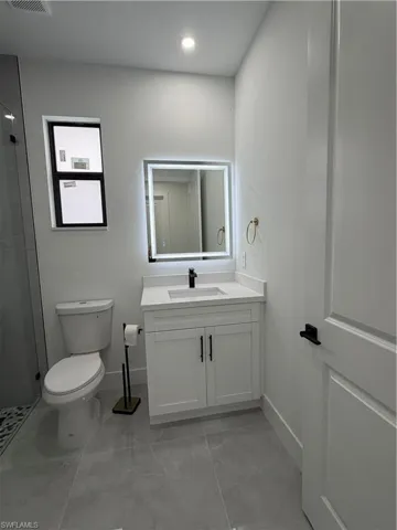Bathroom featuring vanity, a shower stall, and recessed lighting