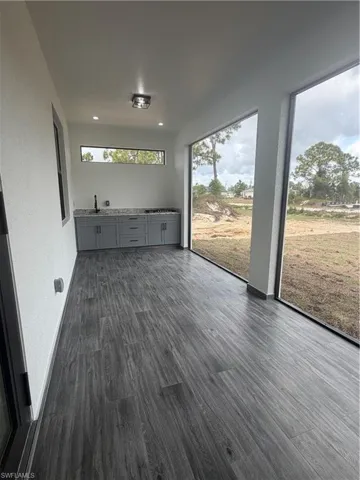 Unfurnished sunroom with a sink