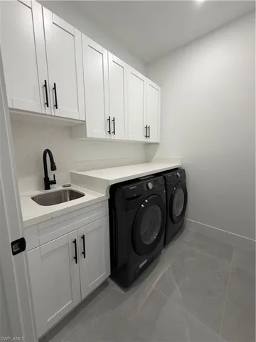 Laundry area featuring washer and dryer and cabinet space