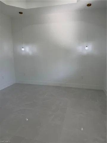 Empty room featuring baseboards