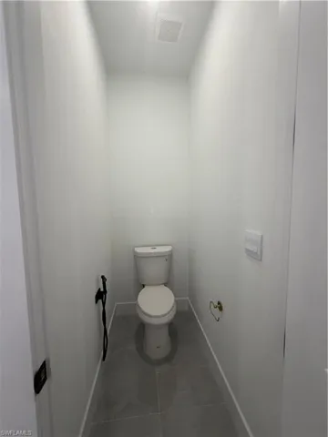 Bathroom with toilet and tile patterned floors