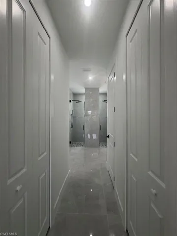 Hallway featuring baseboards