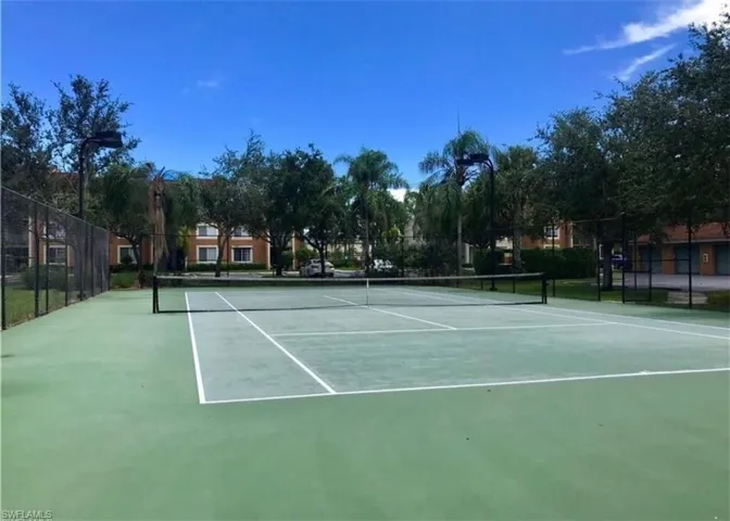 View of tennis court with community basketball court