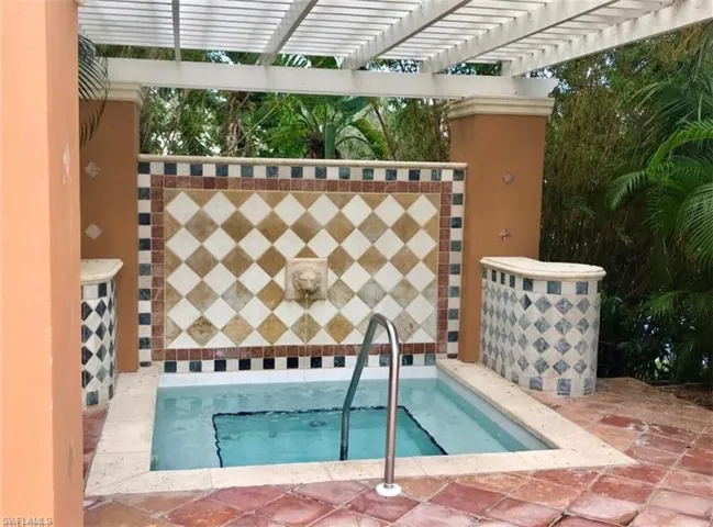View of pool with a patio area and a pergola
