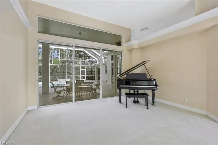 Living room with lanai and pool view