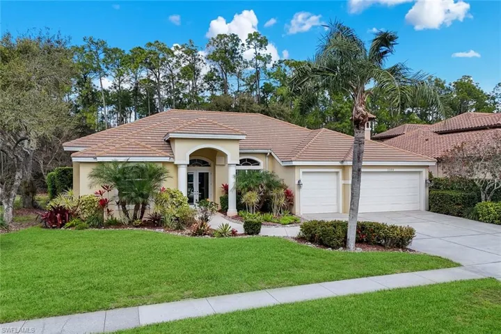 Wilshire Lakes estate pool home featuring a 3 car-garage, concrete driveway, tile roof and preserve backyard for privacy