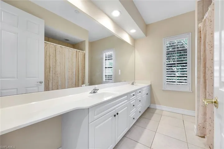 Guest bathroom with double vanity and shower/tub combination