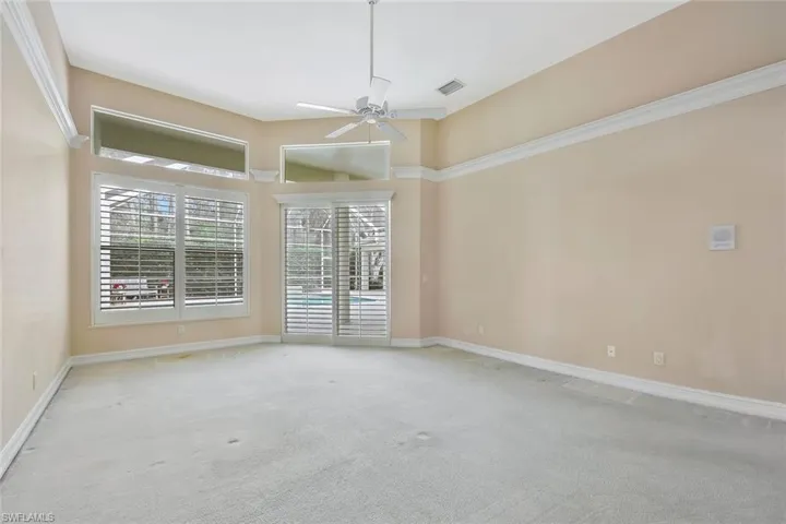 Enormous Primary Bedroom. Double doors leading to the pool and lanai