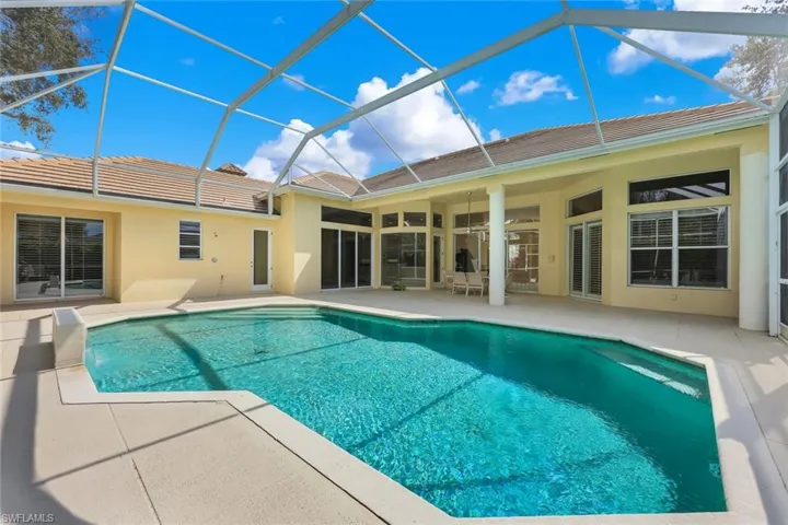 Swimming pool featuring a screened-in covered lanai
