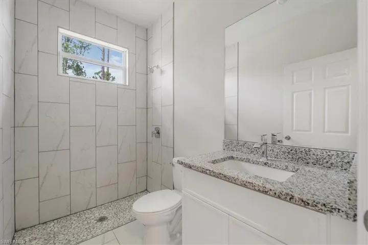 Bathroom featuring vanity and a stall shower