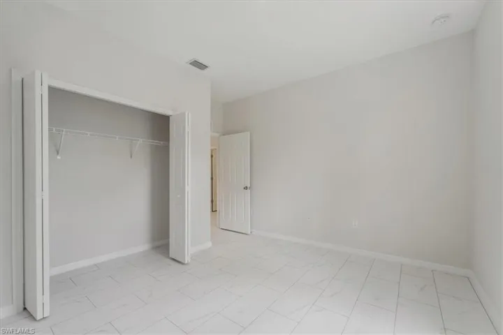 Unfurnished bedroom featuring baseboards and a closet