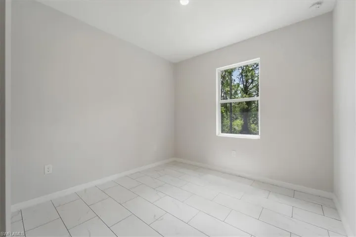 Empty room featuring baseboards and light marble finish flooring