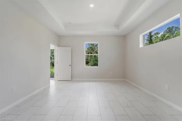 Spare room with plenty of natural light and a raised ceiling