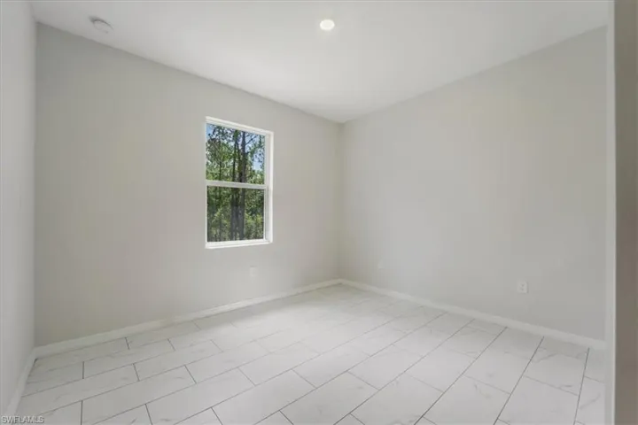 Unfurnished room featuring baseboards