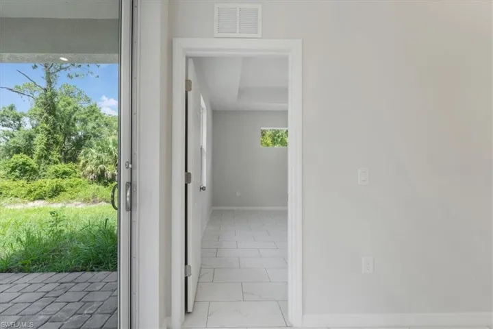 Hall with baseboards and light marble finish flooring