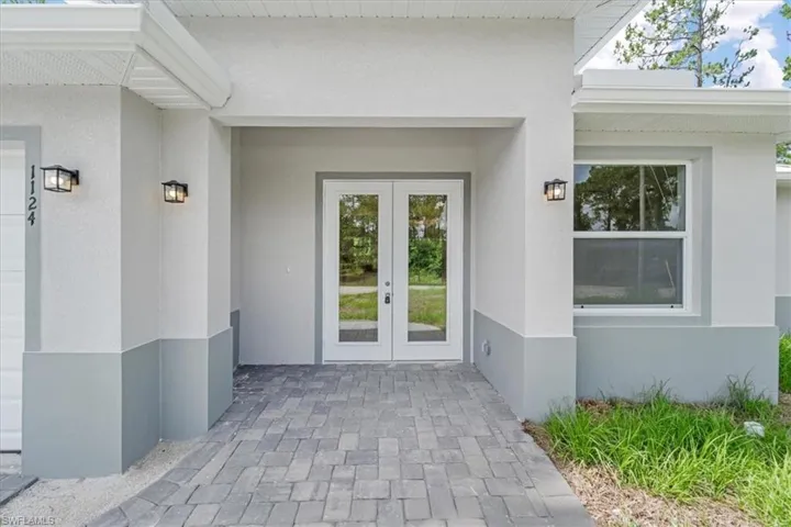 Property entrance with french doors and stucco siding