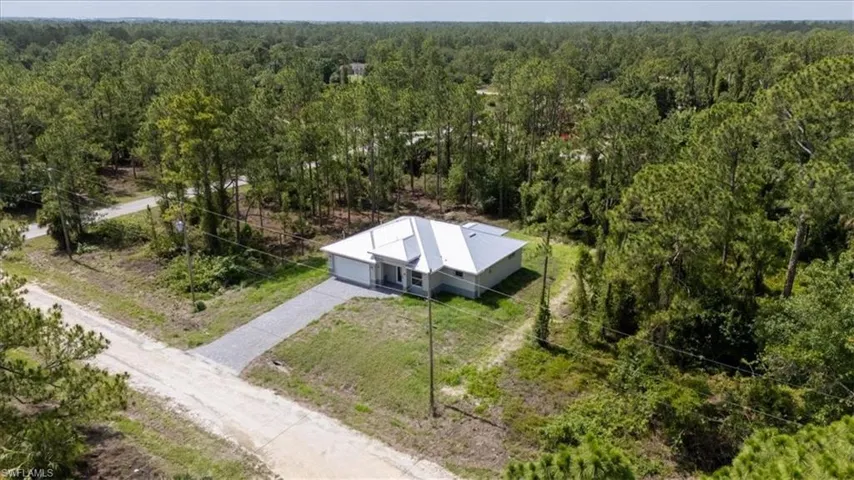 View from above of property with a forest
