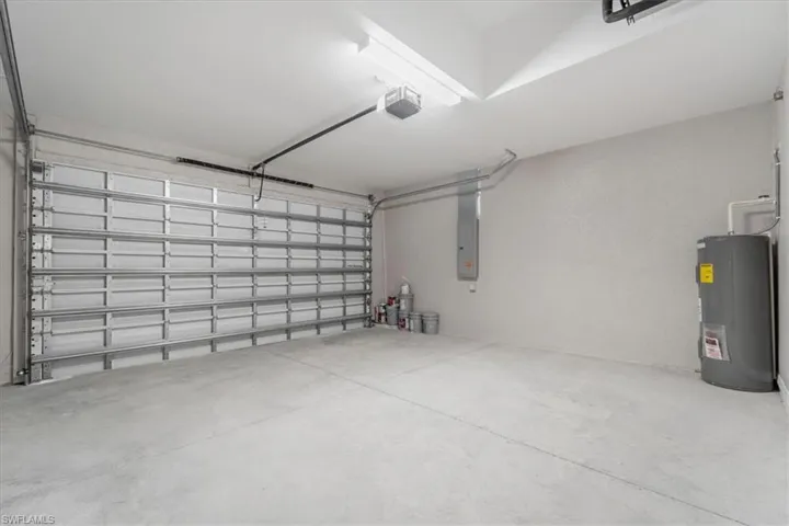Garage with water heater and a garage door opener