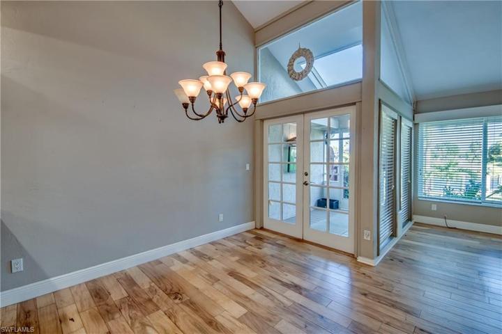 Grand Two Story living room with chandelier going up staircase