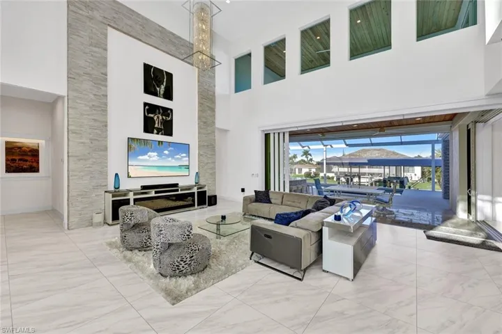 Backlit stack stone accent wall & 20 ft of disappearing pocketing impact sliders leading to your awesome patio area