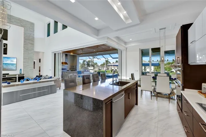 Kitchen features level IV quartz counters w/waterfall edge island, wine cooler & coffee bar