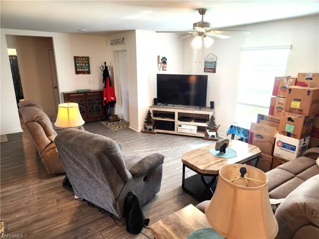Living room featuring ceiling fan and hardwood / wood-style floors