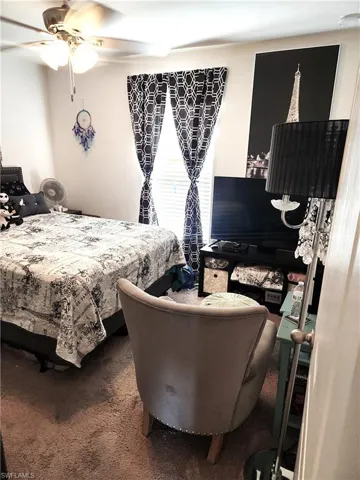 Carpeted bedroom with ceiling fan