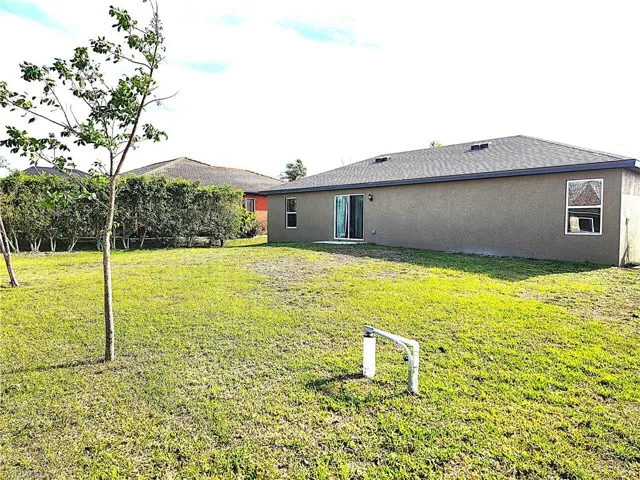 Back of house featuring a lawn