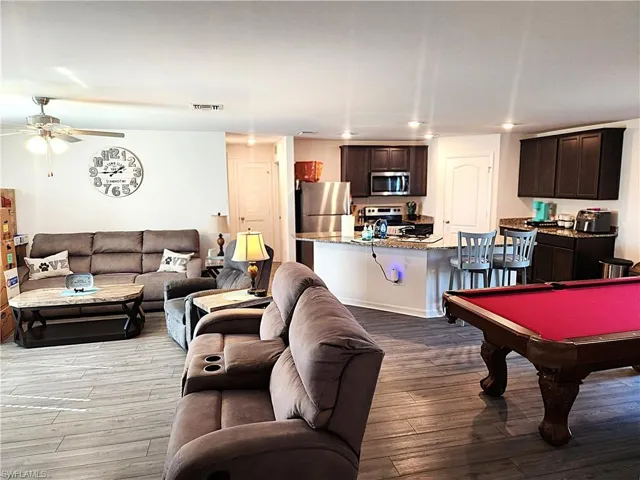 Rec room with light hardwood / wood-style floors, ceiling fan, and pool table