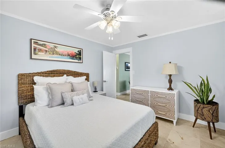 Bedroom with crown molding and a ceiling fan