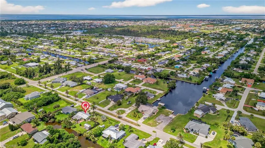 View of property location with a large body of water and nearby suburban area