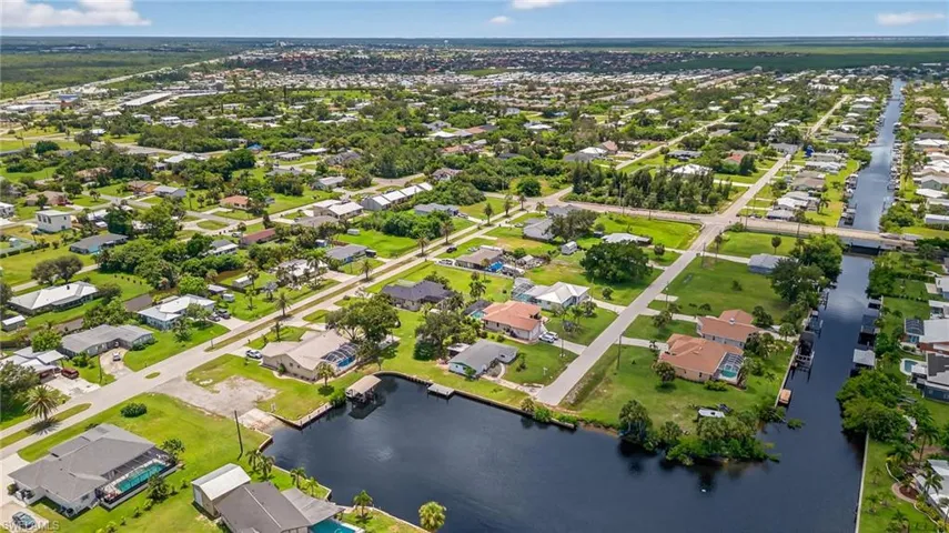 View of property location with a large body of water and nearby suburban area