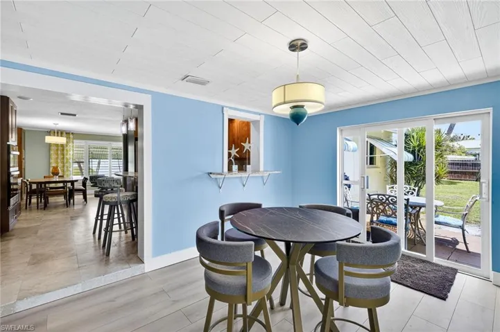 Dining space with plenty of natural light, light wood-type flooring, and wooden ceiling