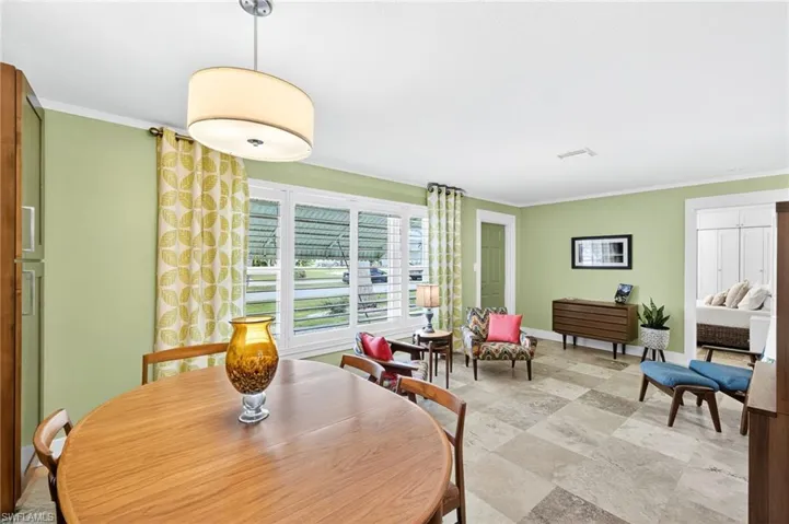 Dining area featuring ornamental molding and baseboards