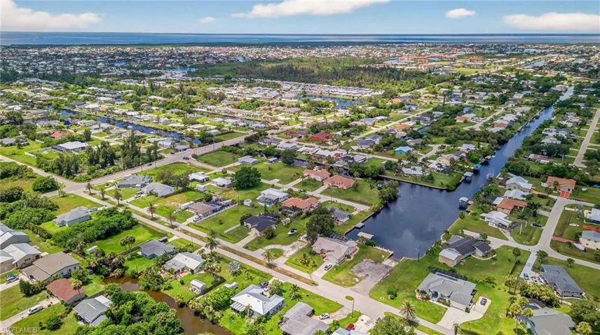 Aerial view of residential area featuring a large body of water