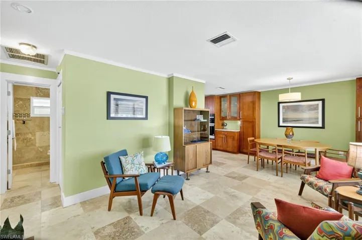 Sitting room with crown molding and baseboards