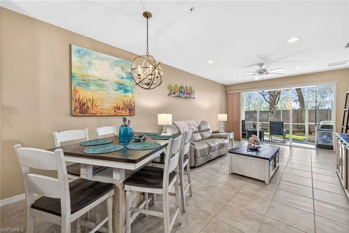 Dining area with recessed lighting, a chandelier, ceiling fan, and light tile patterned floors