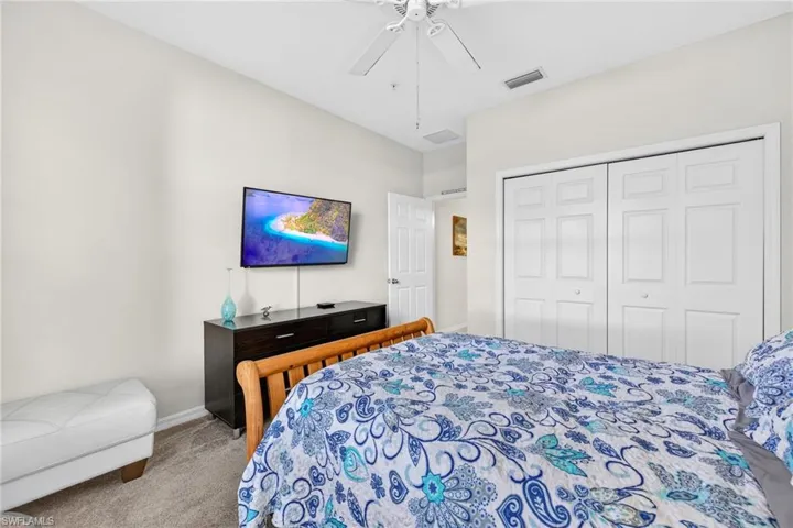 Bedroom featuring carpet, a ceiling fan, and a closet