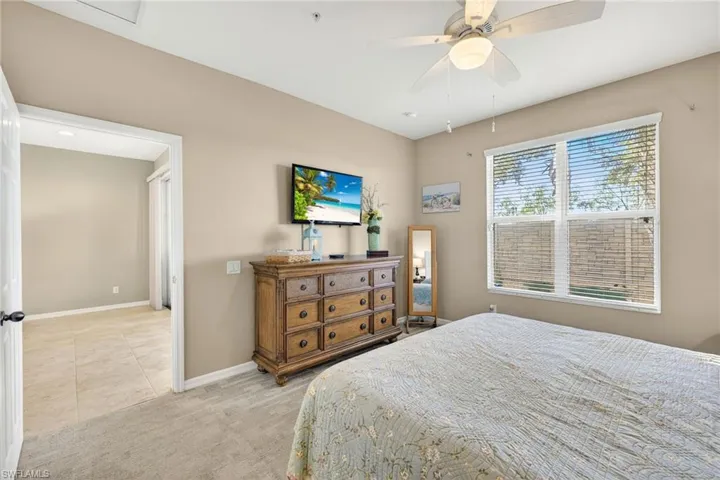 Bedroom featuring light colored carpet and ceiling fan