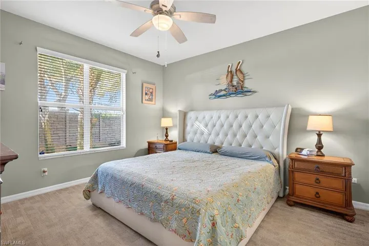 Bedroom with light colored carpet and ceiling fan